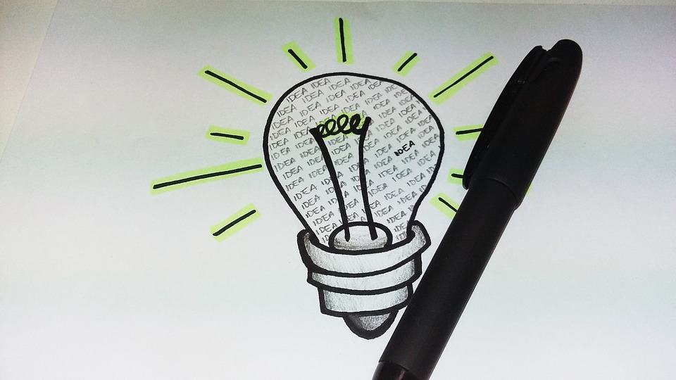 Hand-drawn light bulb filled with the word IDEA repeated, next to a black pen