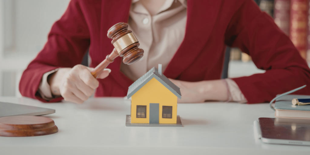 Person in a red blazer holding a gavel