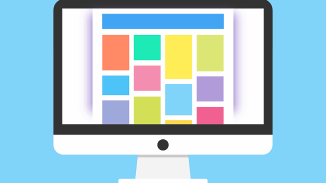 Illustration of a desktop monitor displaying a colourful grid layout, representing premium WordPress theme design