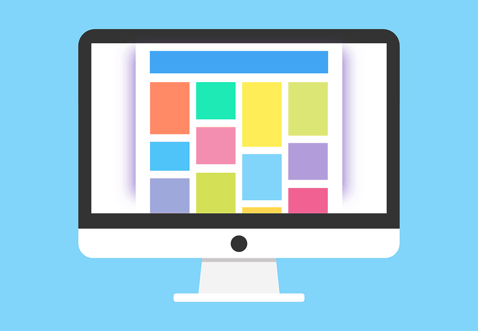 Illustration of a desktop monitor displaying a colourful grid layout, representing premium WordPress theme design