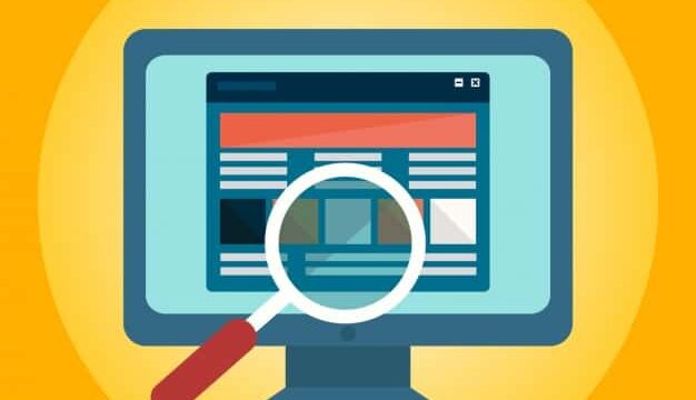 Magnifying glass over a website on a computer monitor, illustrating SEO audit and bad habits to break