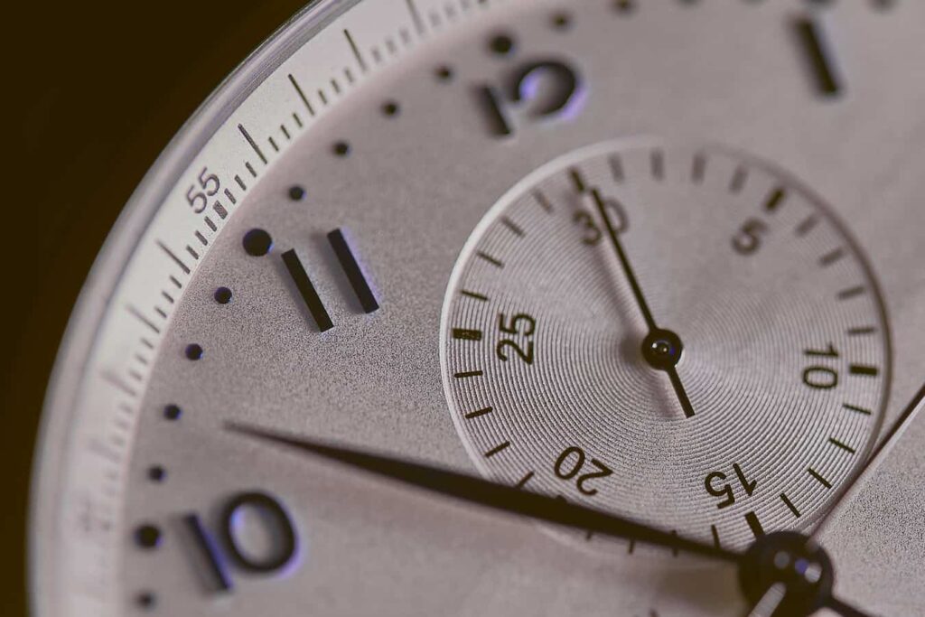 Close-up of a silver chronograph watch face illustrating time management for the Pomodoro technique