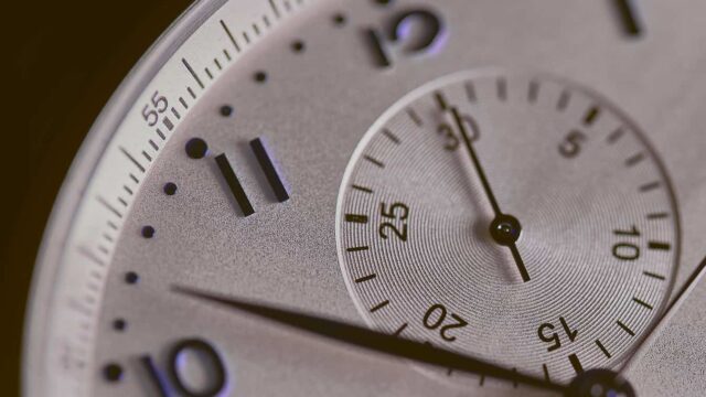 Close-up of a silver chronograph watch face illustrating time management for the Pomodoro technique
