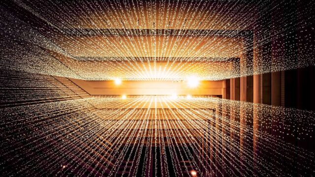 Golden tunnel of glowing light points converging toward a bright vanishing point, abstract digital connectivity concept