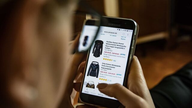 Person browsing Amazon product listings on a Samsung smartphone, illustrating how to rank in Amazon search results