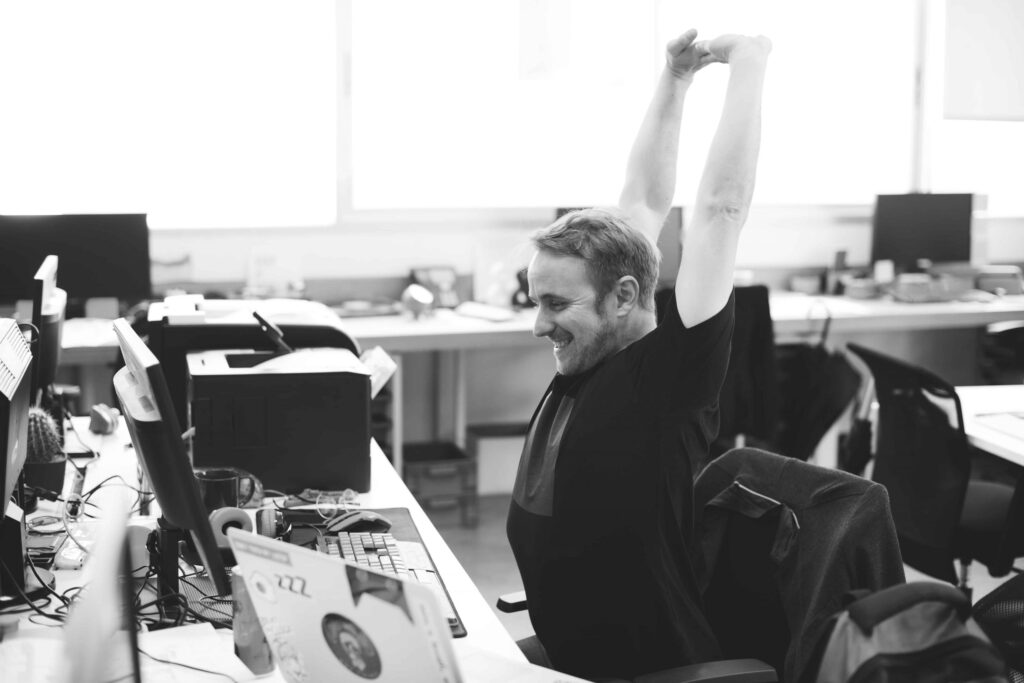 a man in the office stretching