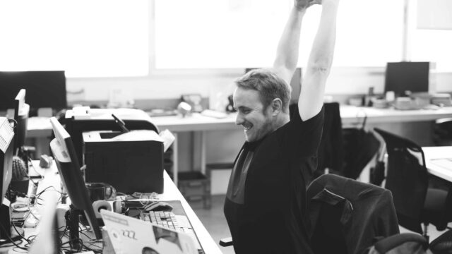 a man in the office stretching