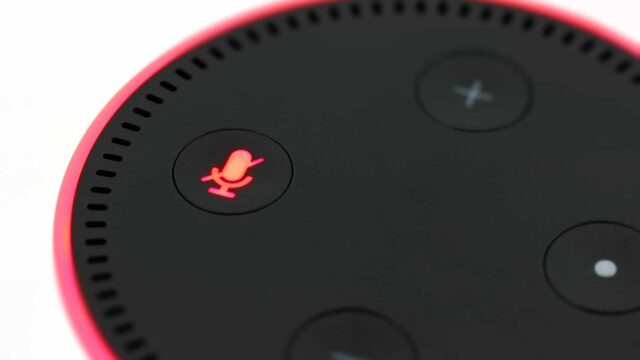 Close-up of an Amazon Echo Dot smart speaker with the muted microphone button glowing red