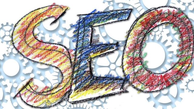 Colourful hand-drawn letters spelling SEO surrounded by interlocking grey gear wheels