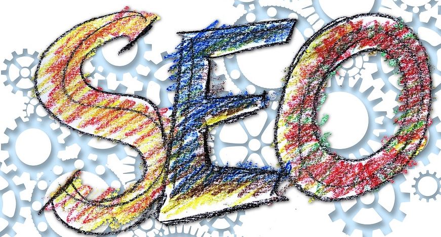 Colourful hand-drawn letters spelling SEO surrounded by interlocking grey gear wheels