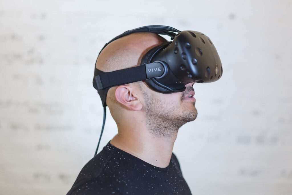 Man wearing HTC Vive virtual reality headset looking upward
