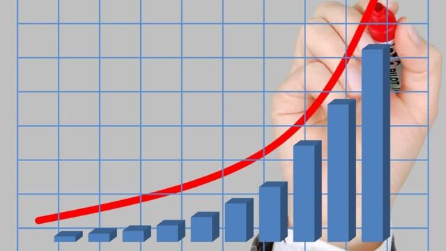 Hand drawing an upward-trending bar and line graph representing AdWords campaign growth