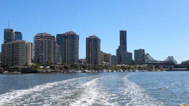 Brisbane city skyline and Story Bridge viewed from the river on a sunny day