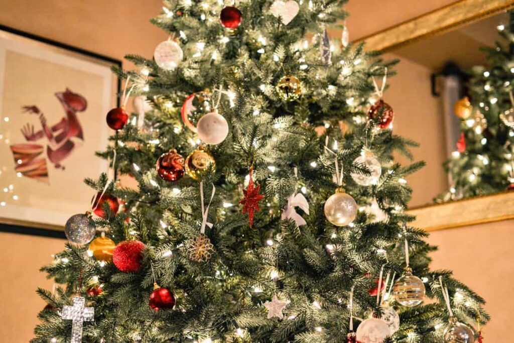 Decorated Christmas tree with red, gold and silver baubles and white fairy lights