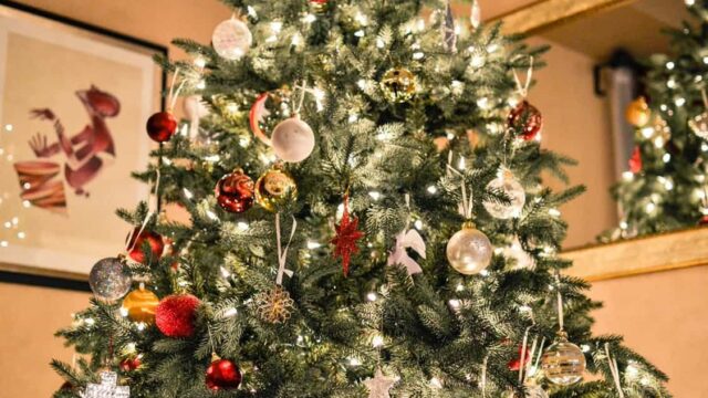 Decorated Christmas tree with red, gold and silver baubles and white fairy lights