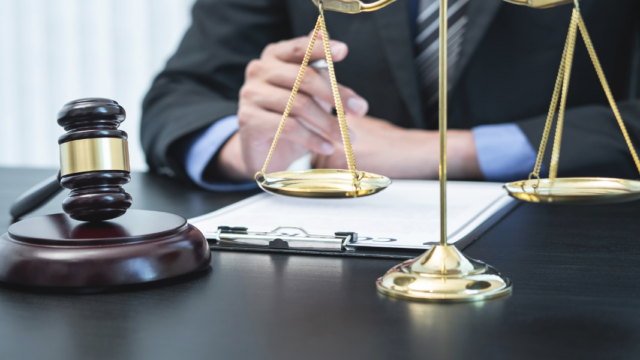 Lawyer with gavel and scales of justice reviewing documents, representing digital marketing for lawyers