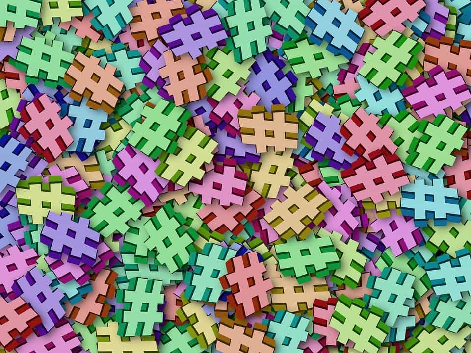 Pile of colourful 3D hashtag symbols in pastel shades illustrating branded hashtag strategy on social media