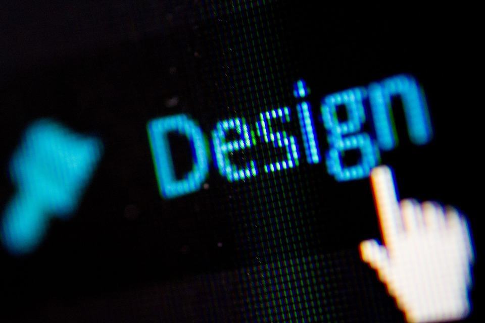 Close-up of the word Design on a dark digital screen with a cursor hand pointer hovering over it