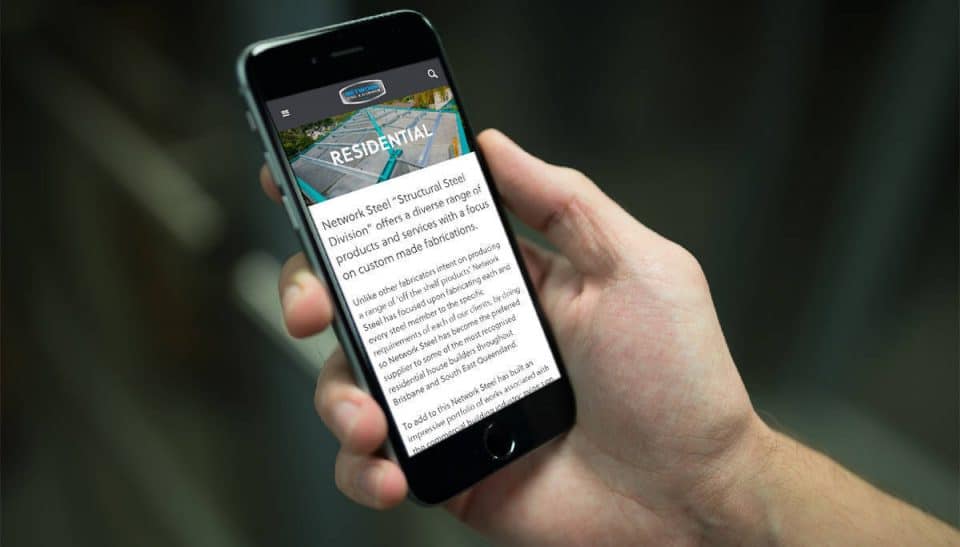 Hand holding a smartphone showing the Network Steel & Aluminium website residential page