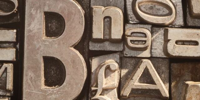 Close-up of vintage metal letterpress type blocks in various sizes and fonts
