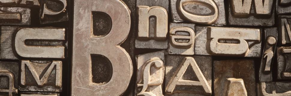 Close-up of vintage metal letterpress type blocks in various sizes and fonts