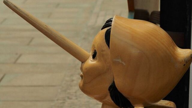 Wooden Pinocchio puppet with an elongated nose, symbolising false promises made by dishonest SEO agencies