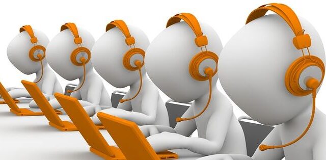 3D figures wearing orange headsets sitting at laptops, representing cold calling SEO sales teams