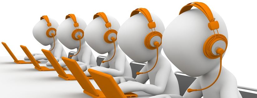 3D figures wearing orange headsets sitting at laptops, representing cold calling SEO sales teams