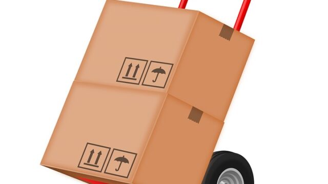 Illustration of a red hand truck loaded with two cardboard shipping boxes, representing an office move
