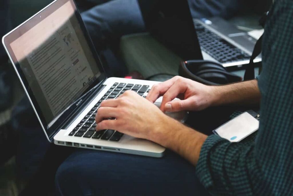 Person typing on a laptop, used as the featured image for the duplicate content SEO article