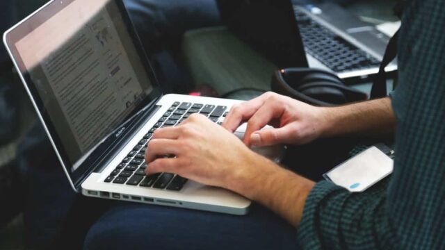 Person typing on a laptop, used as the featured image for the duplicate content SEO article