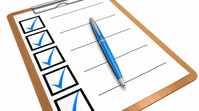 Clipboard with a blue-ticked checklist and pen, illustrating a WordPress SEO checklist