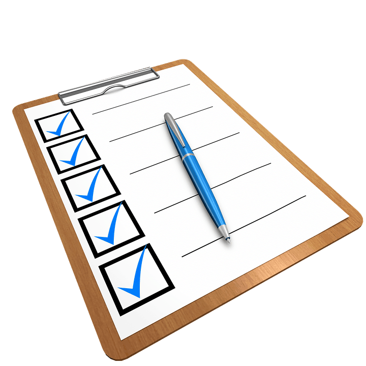 Clipboard with a blue-ticked checklist and pen, illustrating a WordPress SEO checklist